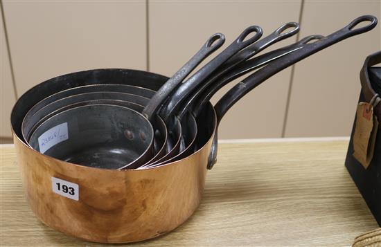 Five copper graduated saucepans